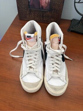 Nike White High-Top Sneakers with Black Swoosh and Yellow Tongue Accents